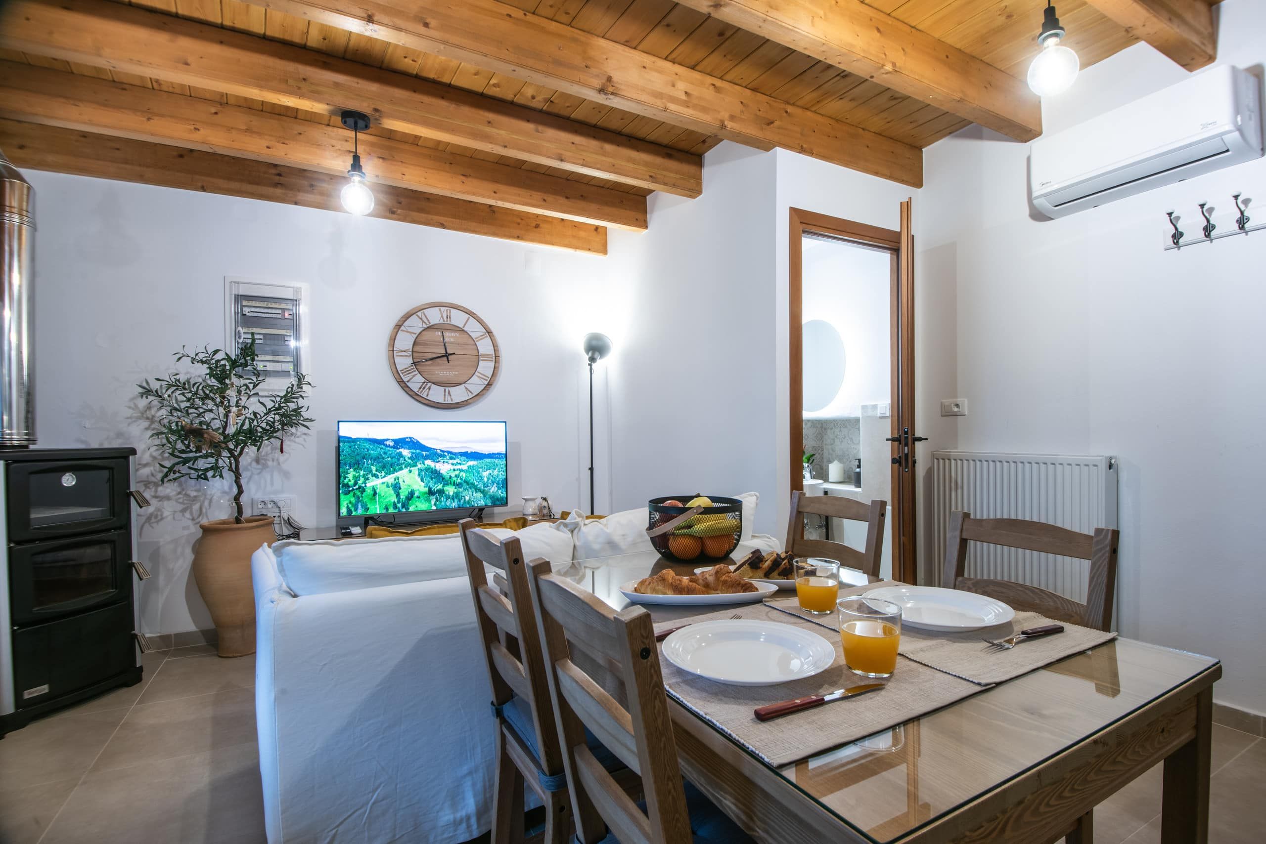 Living room with wood stove, table and TV