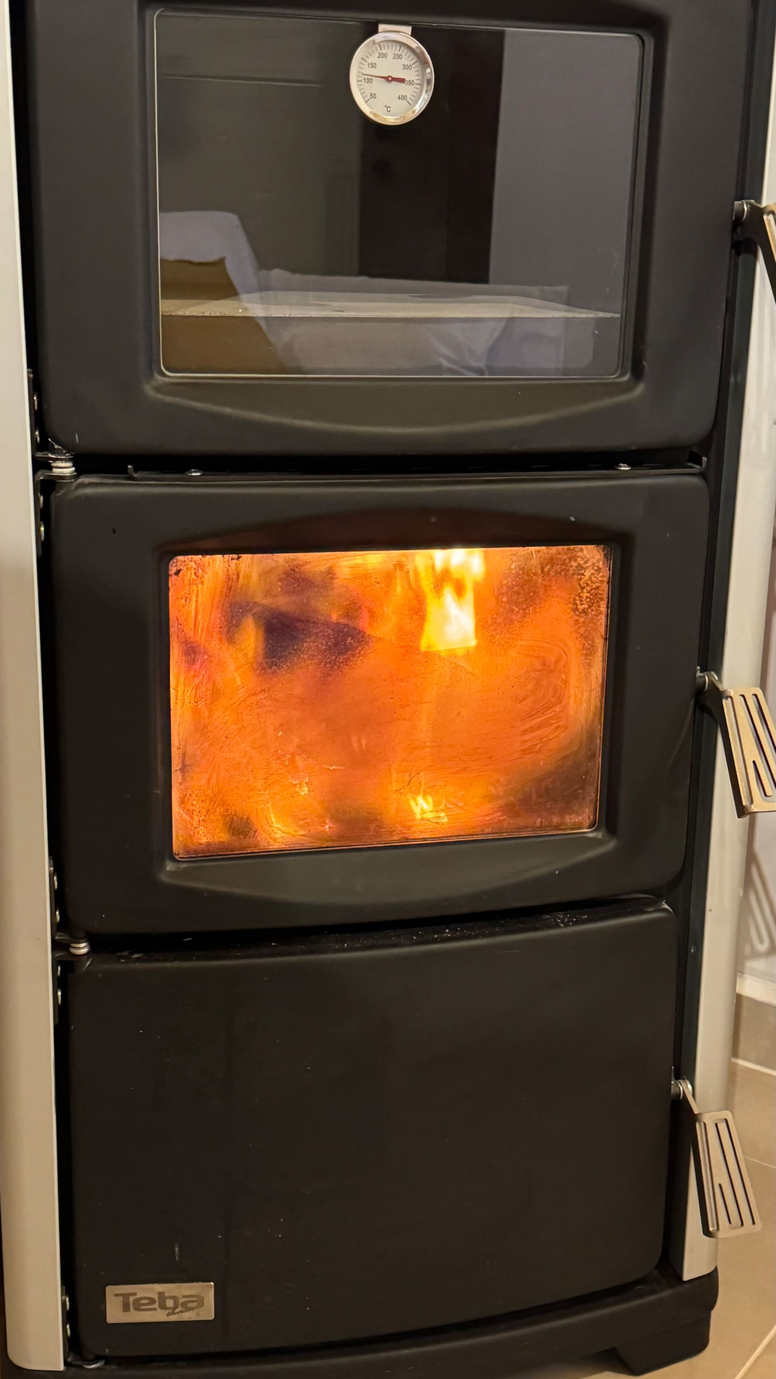 The wood stove in the living space, lit